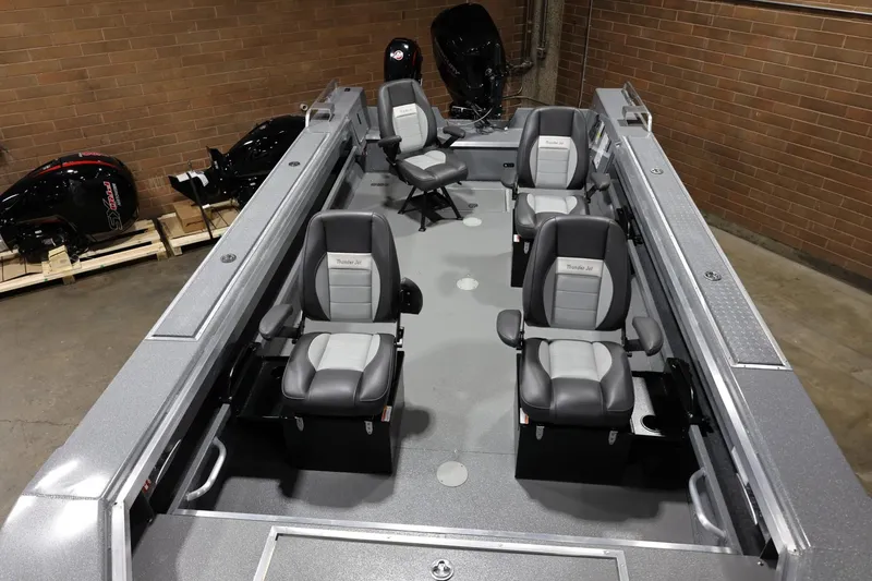 Slide: The Image of 2025 Thunder Jet 209 Rush OT boat interior with four gray seats in a garage setting. - 8