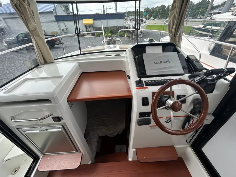 Slide: The Image of 2015 Jeanneau Merry Fisher 855 Marlin helm with Garmin navigation system and wooden steering wheel. - 11