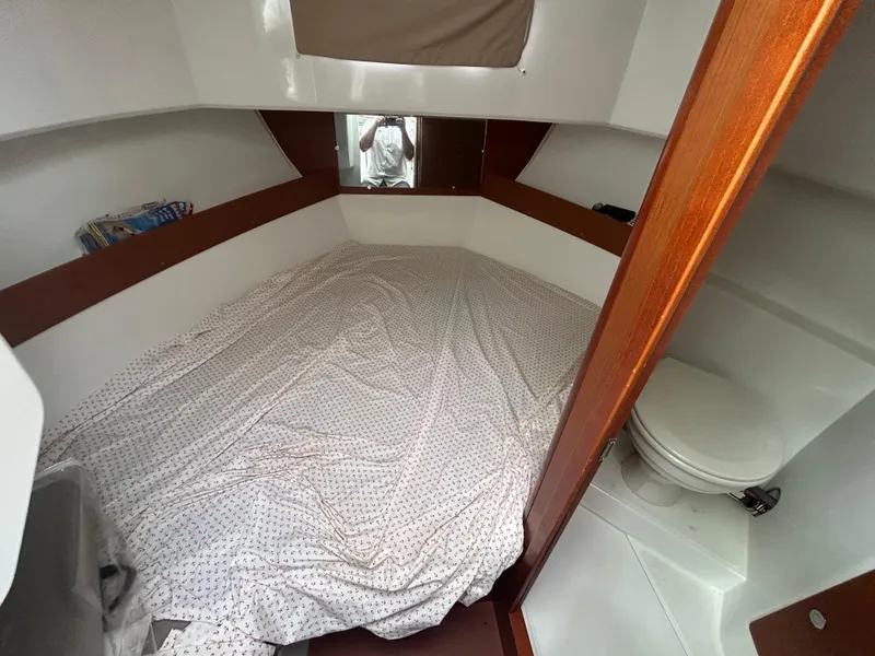 Slide: The Image of 2015 Jeanneau Merry Fisher 855 Marlin cabin interior with bed and compact toilet. - 18