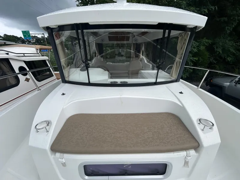 Slide: The Image of 2015 Jeanneau Merry Fisher 855 Marlin boat with spacious deck and cabin view. - 7