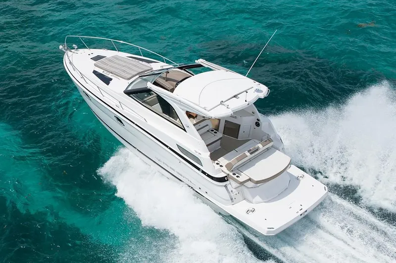 Slide: The Image of 2019 Regal 35 Sport Coupe cruising on clear turquoise waters. - 102