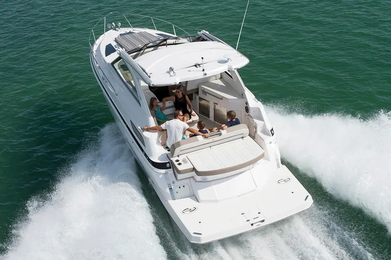 Slide: The Image of 2019 Regal 35 Sport Coupe cruising with passengers on open water. - 103