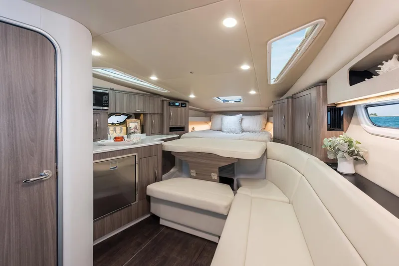 Slide: The Image of Interior of 2019 Regal 35 Sport Coupe yacht with modern kitchen and cozy seating area. - 114