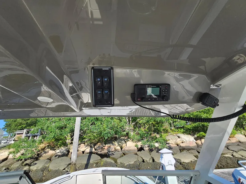 Slide: The Image of 2020 Stingray 269 DC boat dashboard with control panel and Garmin device. - 11