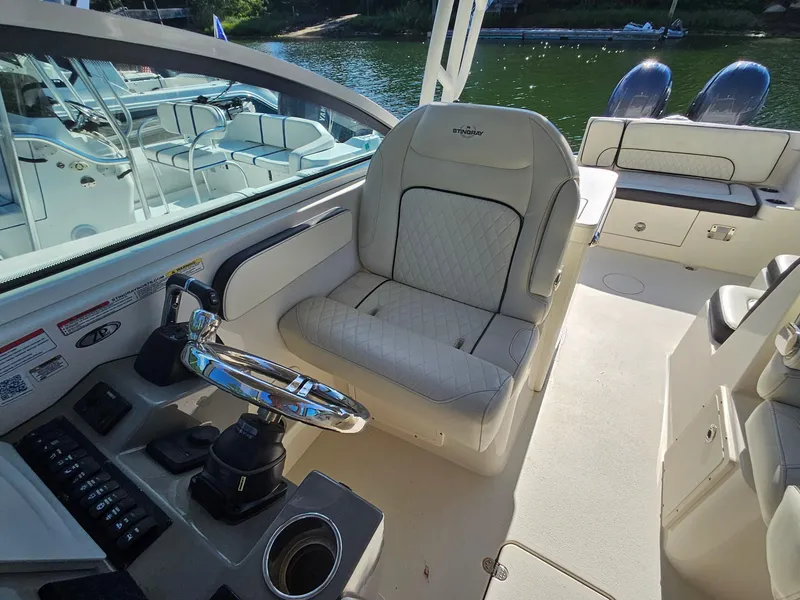 Slide: The Image of 2020 Stingray 269 DC boat interior with steering wheel and seating. - 12