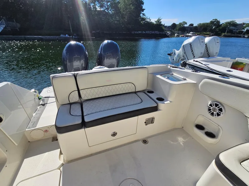 Slide: The Image of 2020 Stingray 269 DC boat interior with seating and dual Honda outboard motors. - 18