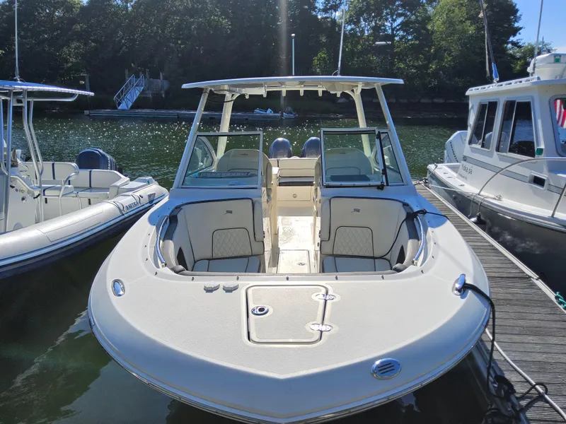 Slide: The Image of 2020 Stingray 269 DC boat docked, featuring spacious seating and sleek design. - 2