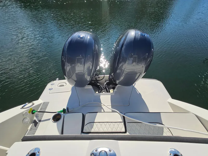 Slide: The Image of 2020 Stingray 269 DC boat with dual outboard motors on calm water. - 20