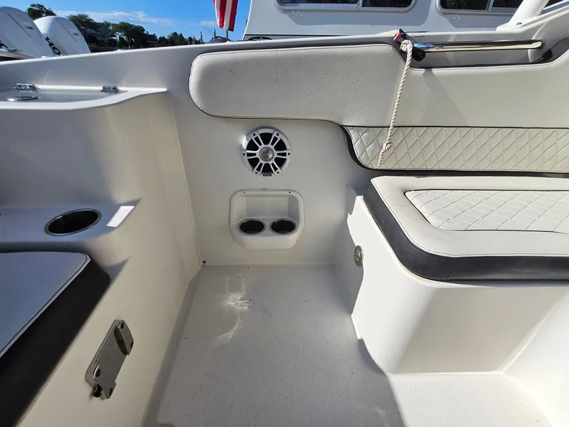 Slide: The Image of 2020 Stingray 269 DC boat interior with cushioned seating and speaker. - 22