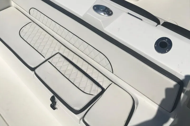 Slide: The Image of 2020 Stingray 269 DC boat interior with white quilted seating and sleek design. - 24