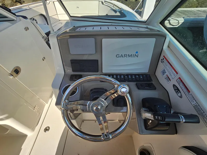 Slide: The Image of 2020 Stingray 269 DC boat dashboard with Garmin navigation system and steering wheel. - 9