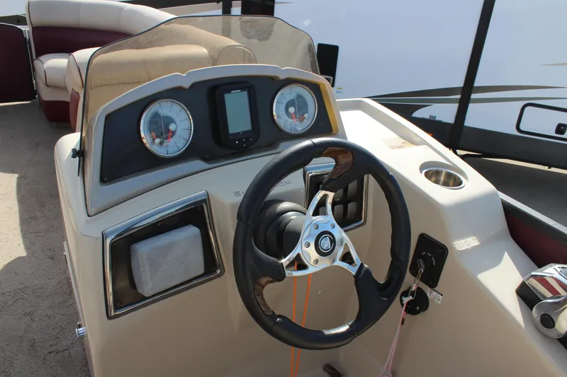 Slide: The Image of Steering console of a 2015 Premier 220 SunSation boat with gauges and controls. - 11