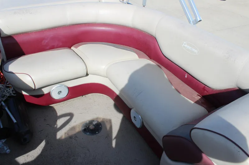 Slide: The Image of 2015 Premier 220 SunSation boat interior with beige and maroon seating. - 12