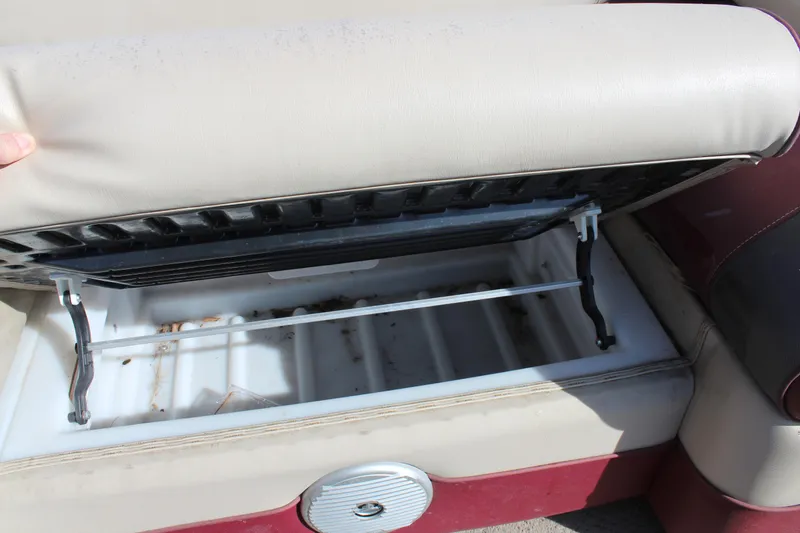 Slide: The Image of 2015 Premier 220 SunSation boat seat storage compartment open, revealing interior space. - 15