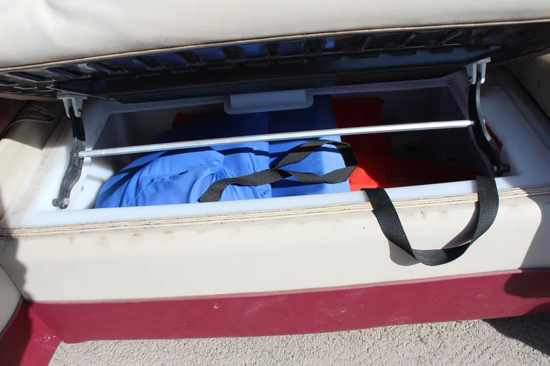 Slide: The Image of Storage compartment in a 2015 Premier 220 SunSation boat with life jackets inside. - 16