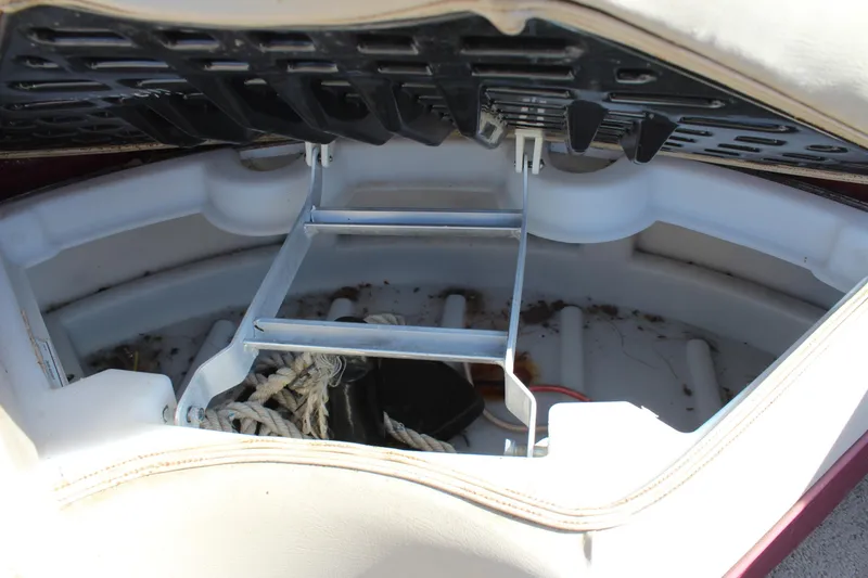 Slide: The Image of 2015 Premier 220 SunSation boat storage compartment with ladder and ropes. - 17