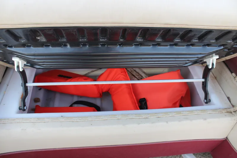 Slide: The Image of Storage compartment with life jackets in a 2015 Premier 220 SunSation boat. - 19