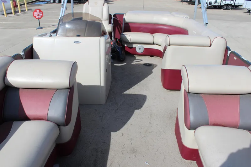 Slide: The Image of 2015 Premier 220 SunSation pontoon boat interior with red and beige seating. - 7