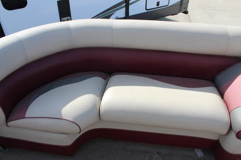 Slide: The Image of Premier 220 SunSation 2015 boat seating with cream and maroon upholstery. - 8