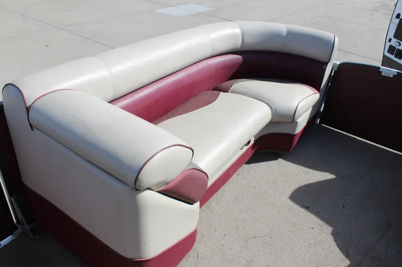 Slide: The Image of 2015 Premier 220 SunSation boat seating, beige and maroon upholstery, outdoor setting. - 9