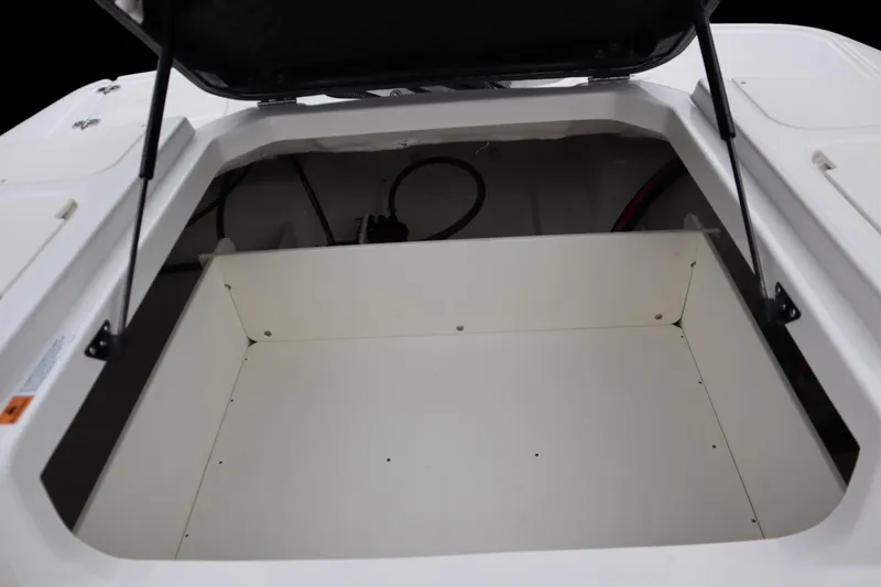 Slide: The Image of 2024 Chaparral 19 SSi OB boat storage compartment, open and empty. - 14