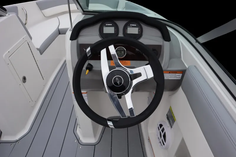 Slide: The Image of 2024 Chaparral 19 SSi OB boat steering wheel and dashboard, featuring modern controls. - 7