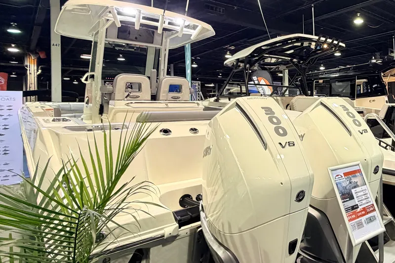Slide: The Image of 2026 Boston Whaler 280 Outrage boat with dual Mercury 300 V8 engines at a boat show. - 4