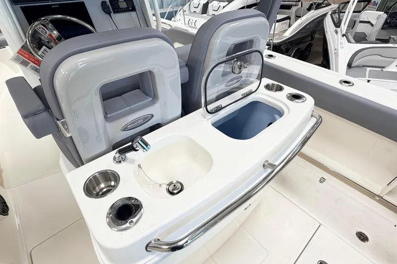 Slide: The Image of 2026 Boston Whaler 280 Outrage boat interior with sink and seating area. - 8