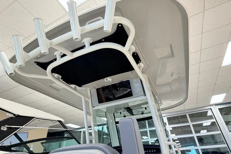 Slide: The Image of 2026 Boston Whaler 280 Outrage boat interior with rod holders and modern design. - 9