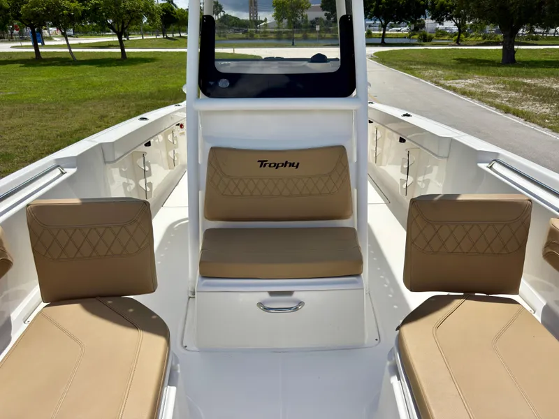 Slide: The Image of 2023 Bayliner Trophy T24CC boat interior with tan seating and white deck. - 10
