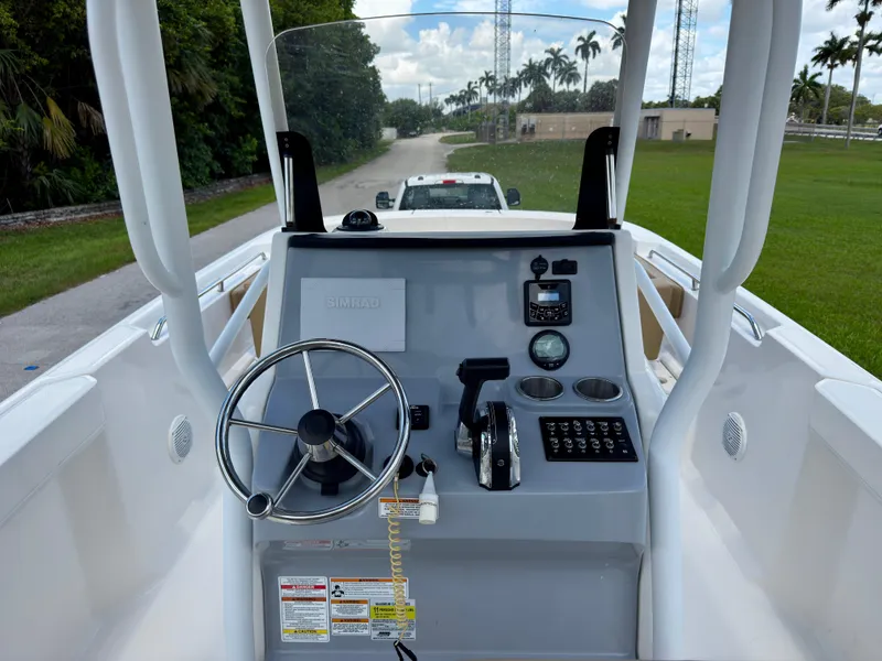 Slide: The Image of 2023 Bayliner Trophy T24CC boat console with steering wheel and controls. - 14