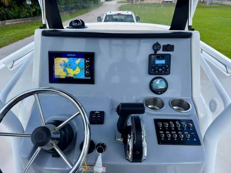 Slide: The Image of 2023 Bayliner Trophy T24CC boat dashboard with navigation system and controls. - 15