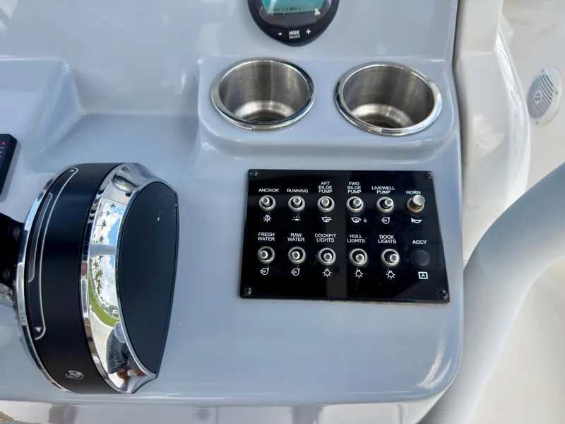 Slide: The Image of Control panel of 2023 Bayliner Trophy T24CC boat with switches and cup holders. - 19