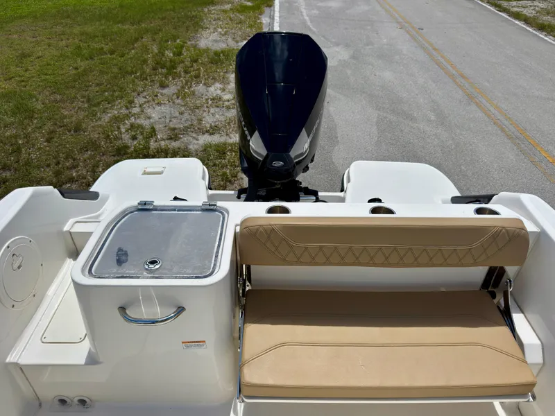 Slide: The Image of 2023 Bayliner Trophy T24CC boat with outboard motor and seating area. - 20