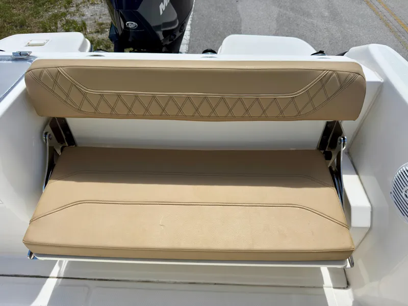 Slide: The Image of 2023 Bayliner Trophy T24CC tan cushioned boat seat with diamond stitching. - 21