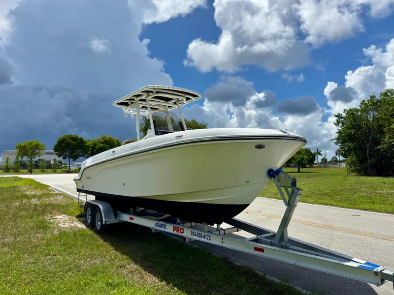 Slide: The Image of 2023 Bayliner Trophy T24CC boat on trailer under cloudy sky. - 3