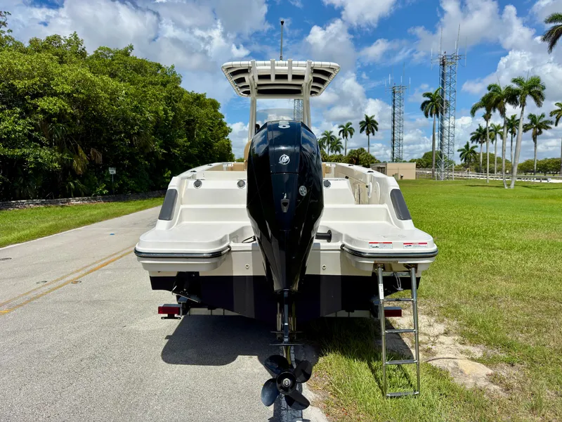 Slide: The Image of 2023 Bayliner Trophy T24CC boat with outboard motor, parked on a sunny day. - 5