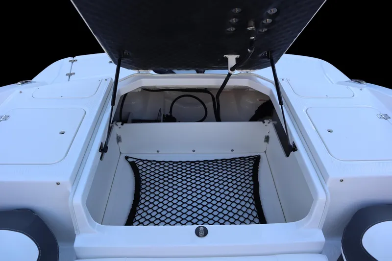 Slide: The Image of 2024 Chaparral 21 SSi Ski & Fish OB storage compartment with open hatch and netting. - 11