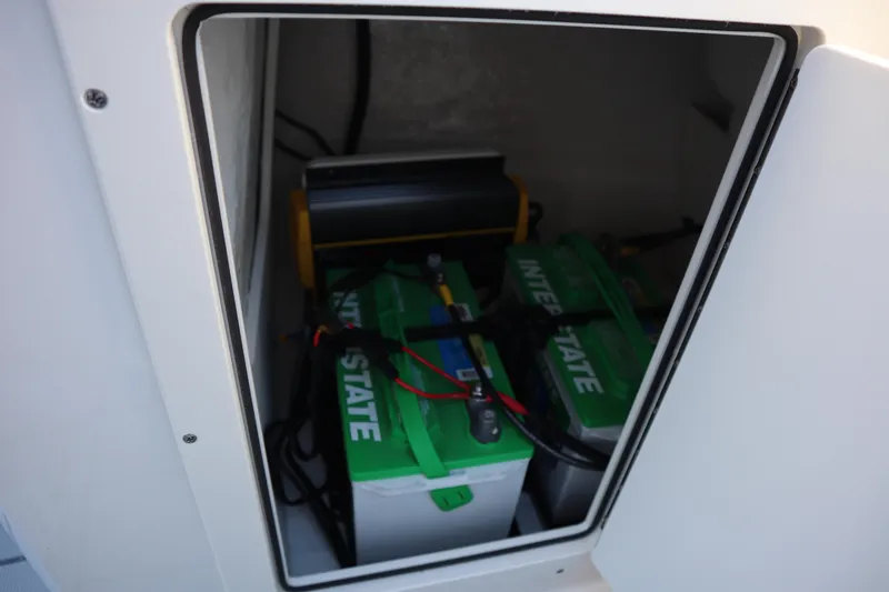 Slide: The Image of 2024 Chaparral 21 SSi Ski & Fish OB battery compartment with Interstate batteries. - 15