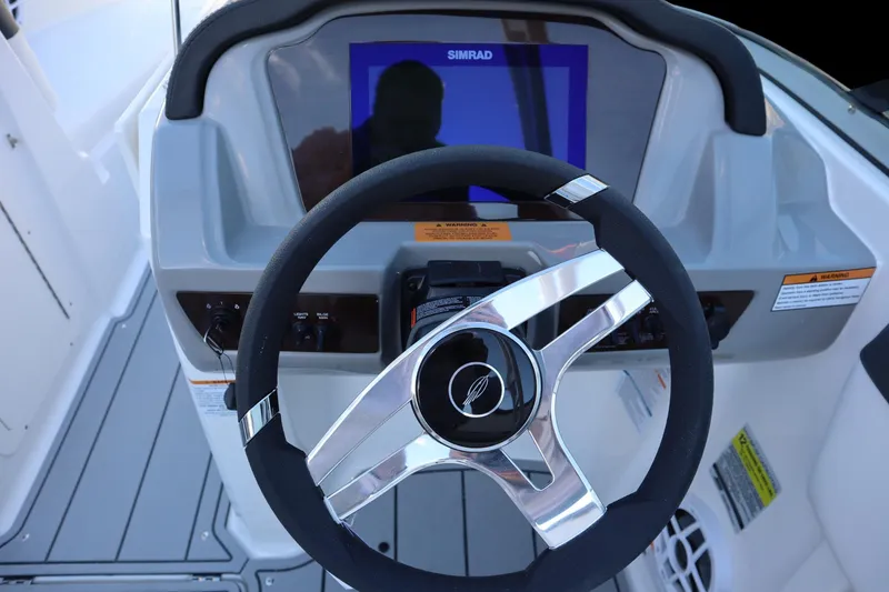 Slide: The Image of 2024 Chaparral 21 SSi Ski & Fish OB dashboard with steering wheel and Simrad display. - 4