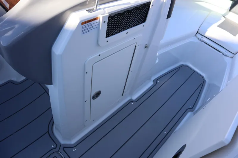 Slide: The Image of 2024 Chaparral 21 SSi Ski & Fish OB boat interior with storage compartment and non-slip flooring. - 8