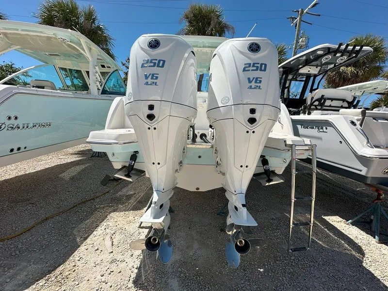 Slide: The Image of 2025 Sailfish 276 DC boat with twin 250 V6 A2L engines, parked outdoors. - 10