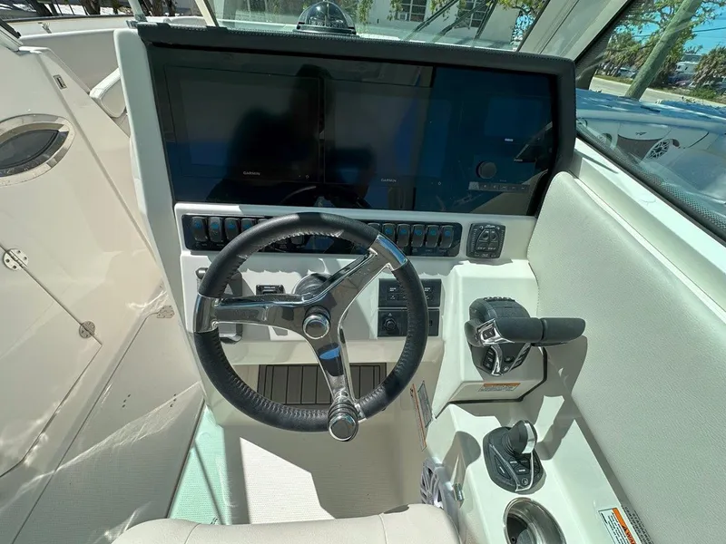 Slide: The Image of 2025 Sailfish 276 DC boat helm with steering wheel and control panel. - 15