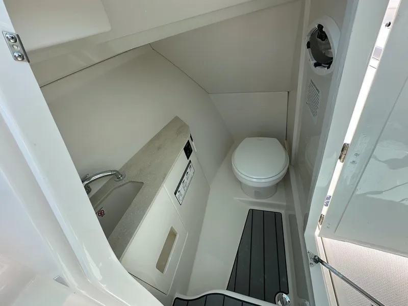 Slide: The Image of 2025 Sailfish 276 DC boat interior bathroom with toilet and sink. - 18