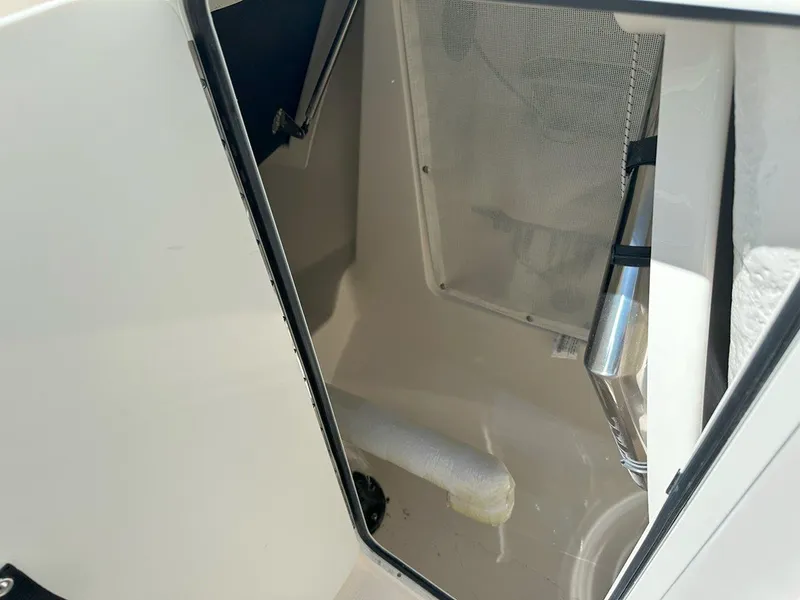 Slide: The Image of Interior view of 2025 Sailfish 276 DC boat compartment with storage space. - 19