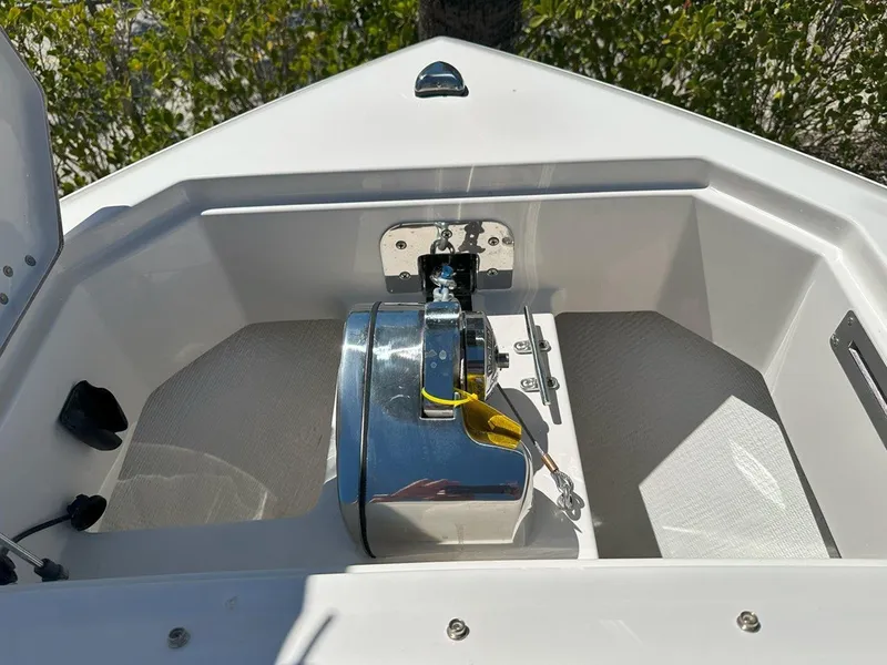 Slide: The Image of 2025 Sailfish 276 DC boat anchor compartment with chrome winch and clean design. - 20
