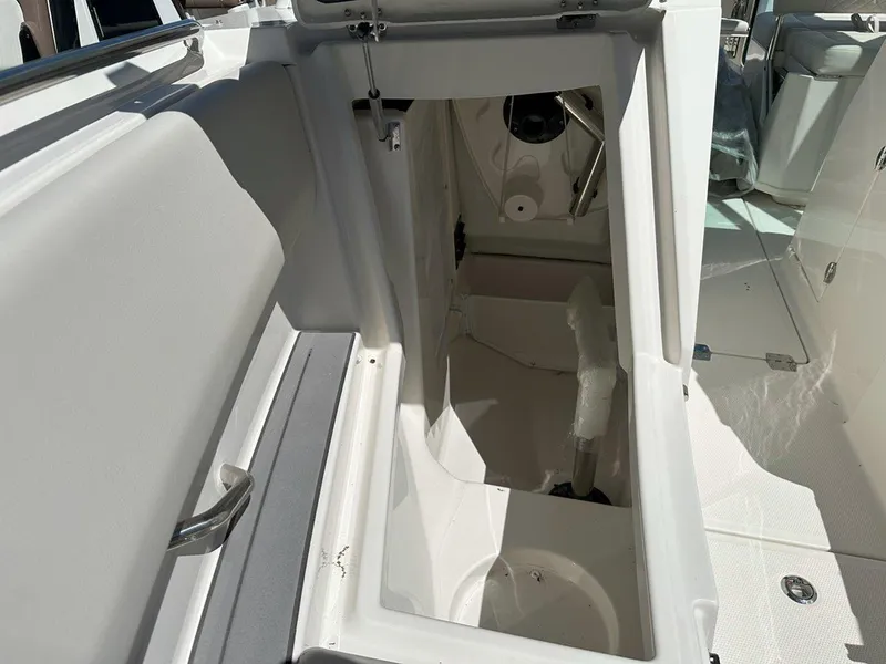 Slide: The Image of 2025 Sailfish 276 DC boat storage compartment with open hatch, showcasing interior space. - 21