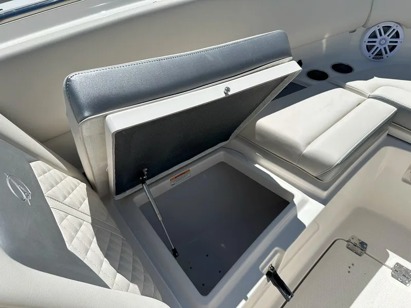 Slide: The Image of 2025 Sailfish 276 DC boat interior storage compartment with cushioned seating. - 22