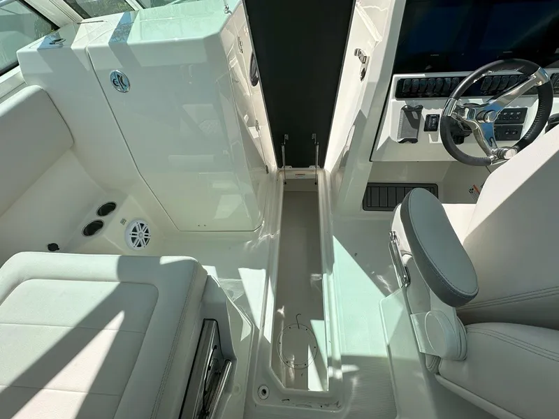 Slide: The Image of Interior view of 2025 Sailfish 276 DC boat cockpit with steering wheel and seating. - 24