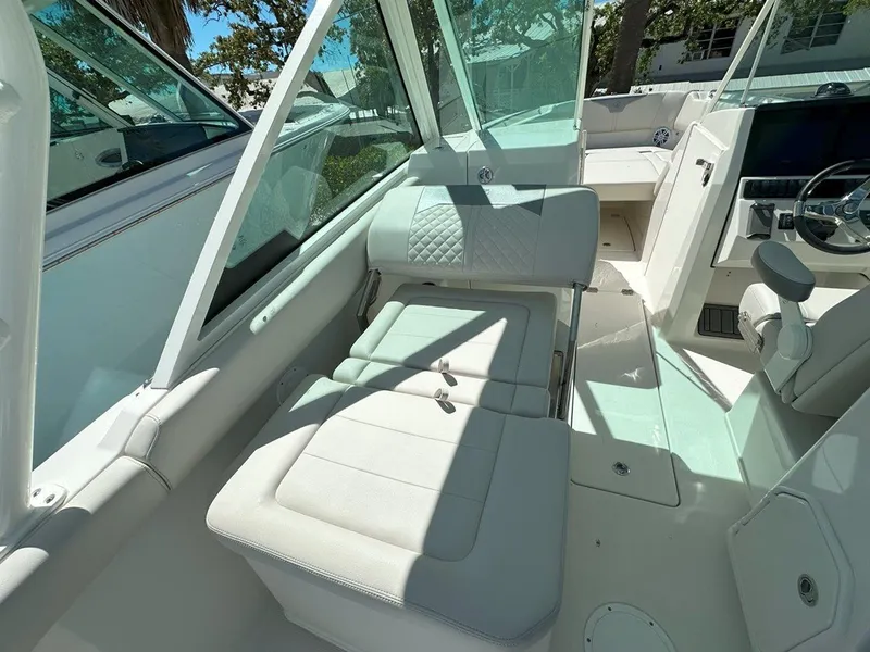 Slide: The Image of 2025 Sailfish 276 DC boat interior with white seating and modern dashboard. - 27